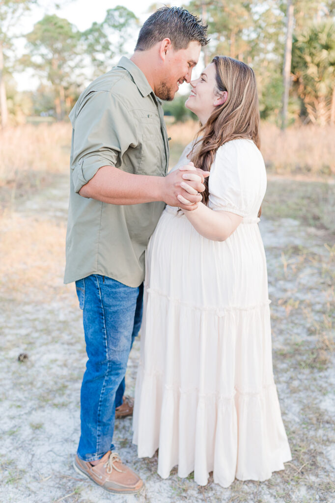 South Florida Maternity photo session, husband and wife dancing during golden hour sunset.